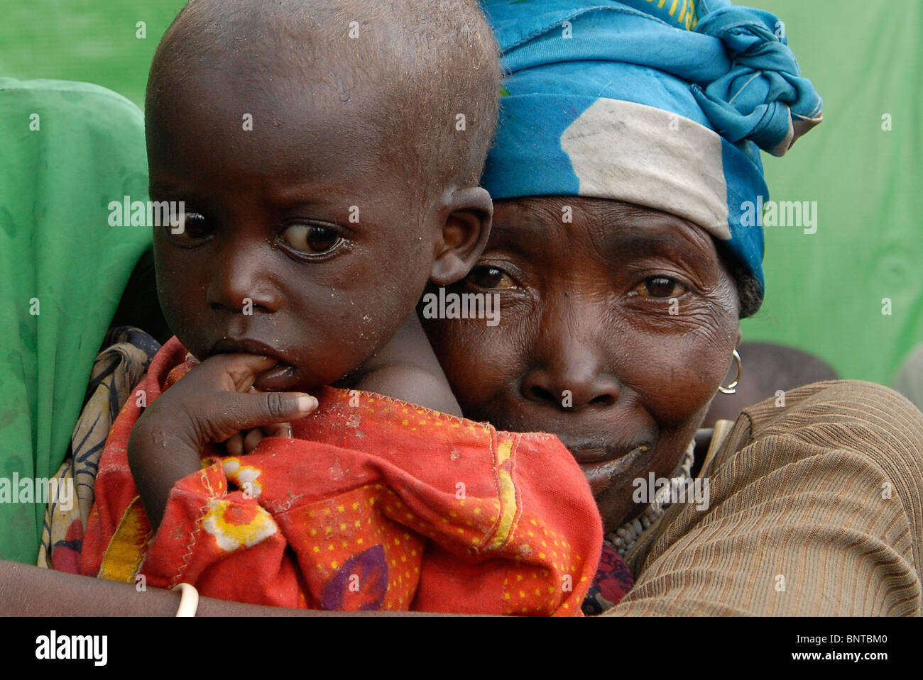 Displaced Congolese woman with a malnourished toddler look dejected in an IDP camp in North Kivu, Congo DR central Africa Stock Photo