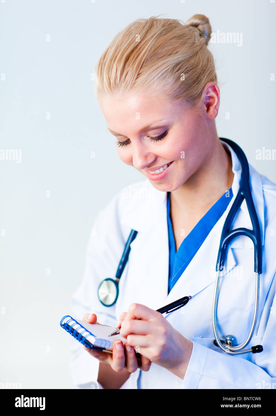 Female doctor writing a perscription Stock Photo - Alamy