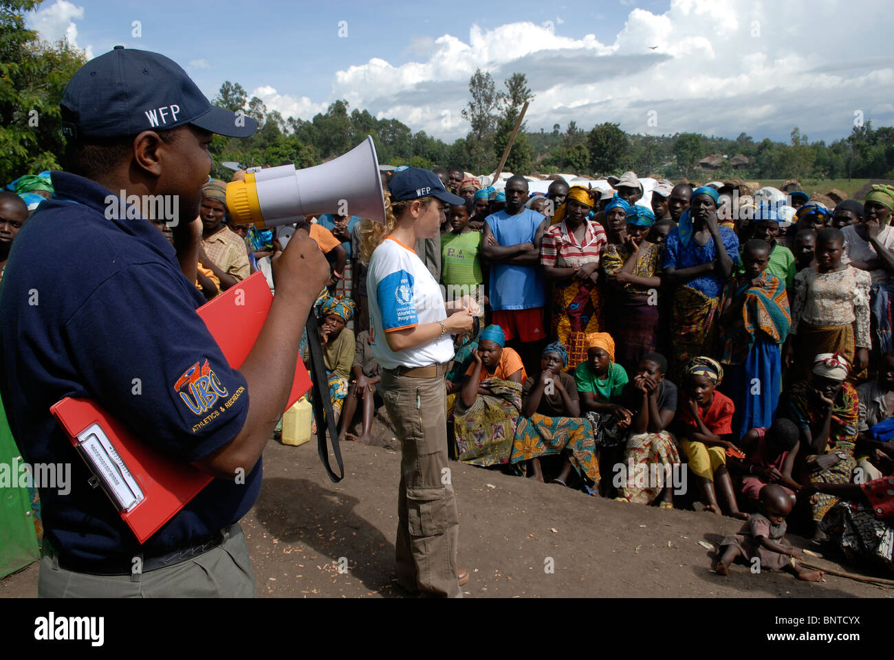 Field operations managers of World Food Programme WFP speak to internally displaced people in a makeshift  IDP camp in North Kivu province DR Congo Africa Stock Photo