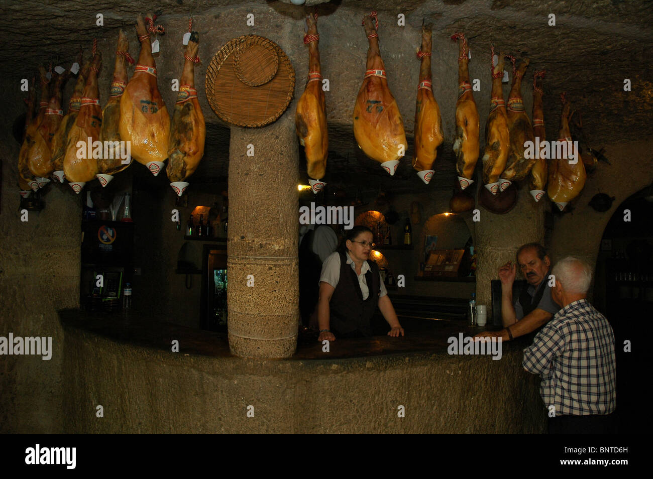 Jamon Serrano and Jamon Iberico hams hang in the bar restaurant Tagoror built inside a cave in Barranco de Guayadeque nature reserve in Gran Canaria island one of Spain’s Canary Islands Stock Photo