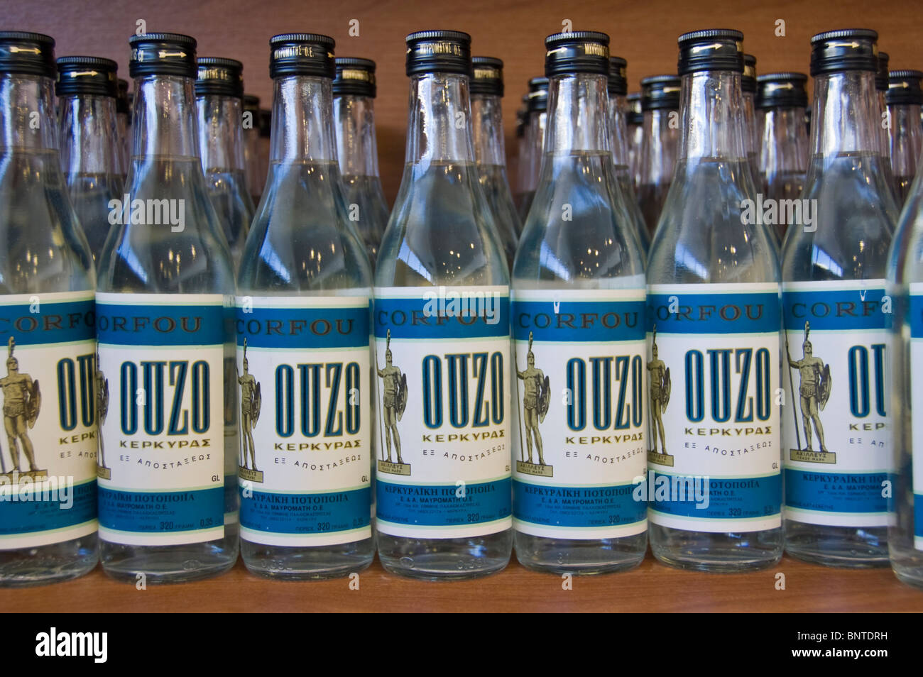 Bottles of Ouzo for sale in tourist shop at distillery in Mavromatis on the Greek Mediterranean island of Corfu Greece GR Stock Photo