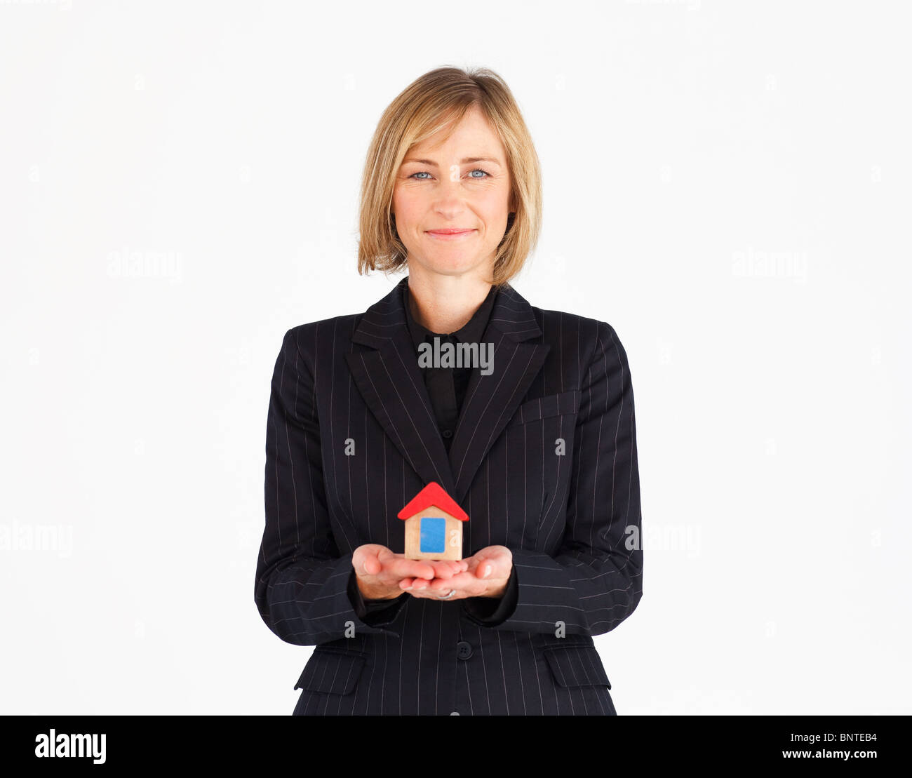Cute businesswoman presenting a model of house Stock Photo - Alamy
