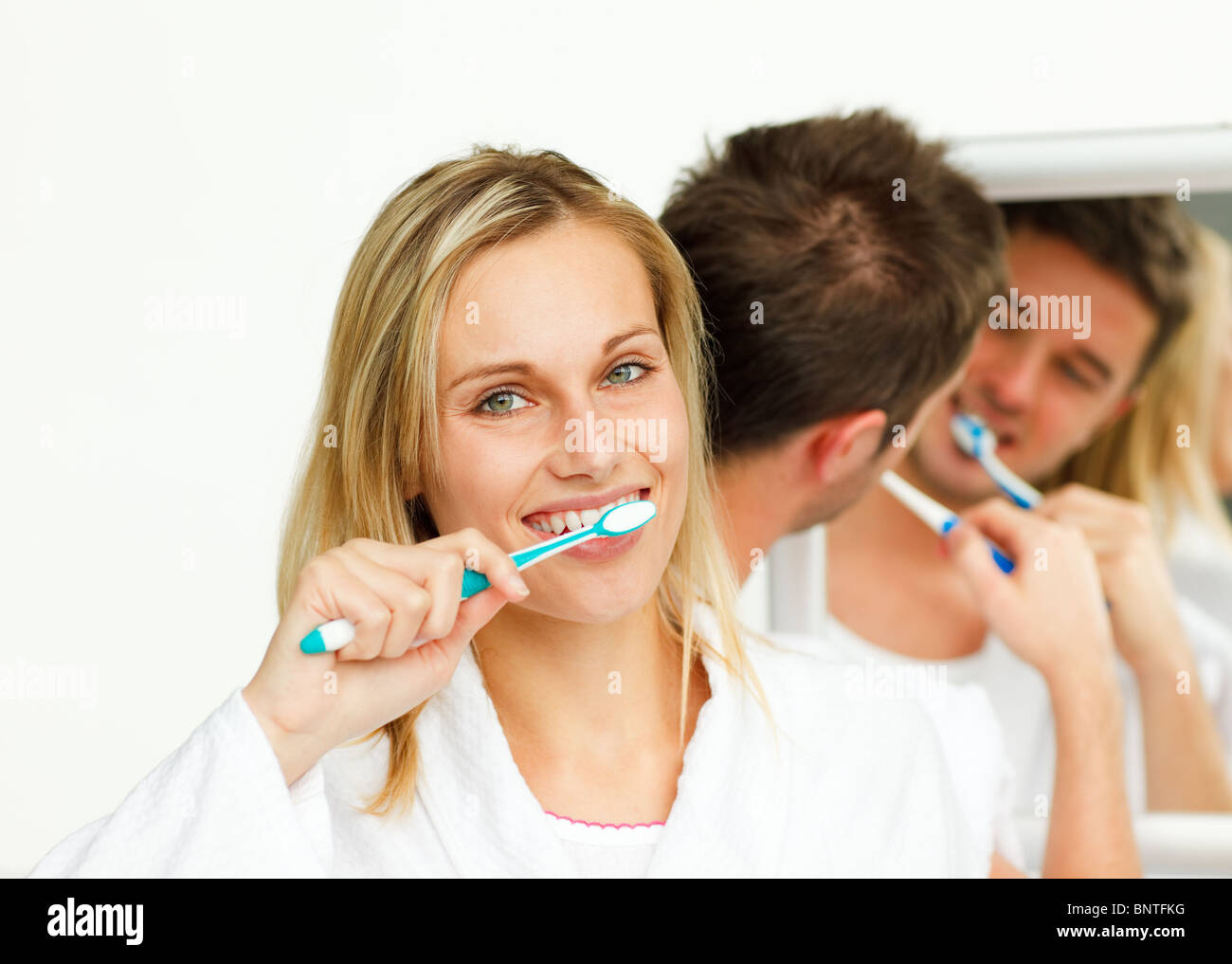 Young woman cleaning her teeth with her boyfriend Stock Photo Alamy