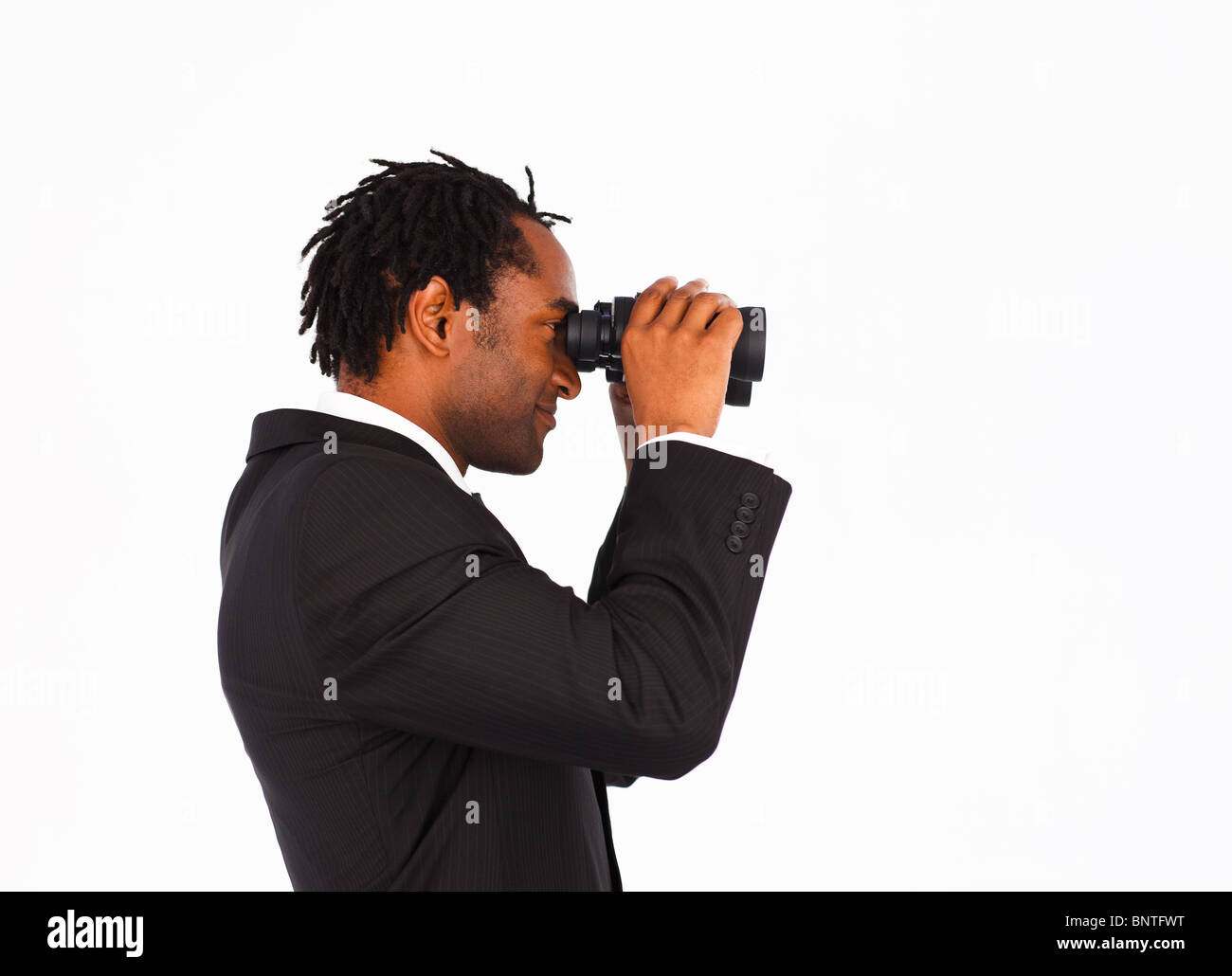 Sidewise closeup of a cute businessman with binoculars Stock Photo