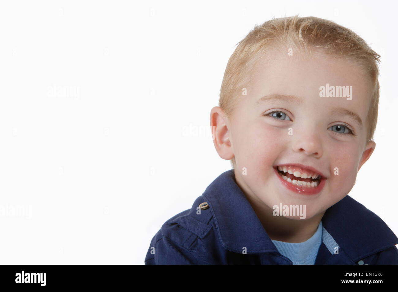 Close-up of Young Boy in Blue Shirt Smiling into Camera Stock Photo - Alamy