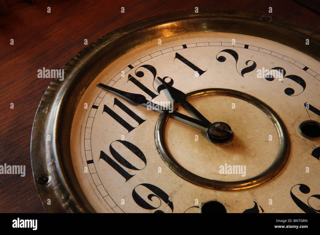 Face of an antique clock; indicating nearly midnight Stock Photo