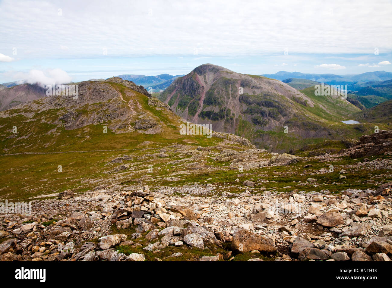 View from Scafell Pike, Lingmell in foreground, Great Gable centre and Styhead Tarn below, Derwent Water in far right distance. Stock Photo