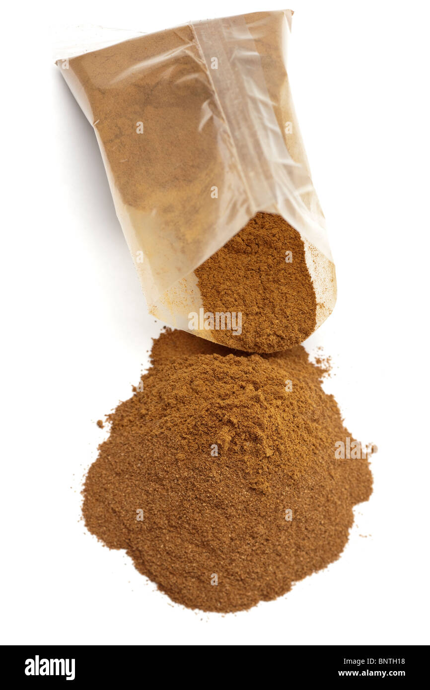 Pile of Cinnamon spilling from a small sachet Stock Photo