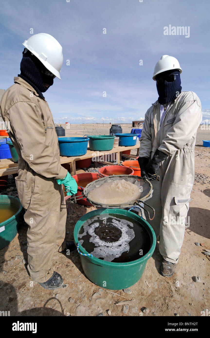 Bolivian workers at a pilot lithium extraction factory in the Salar de Uyuni, the largest salt desert in the World. Stock Photo