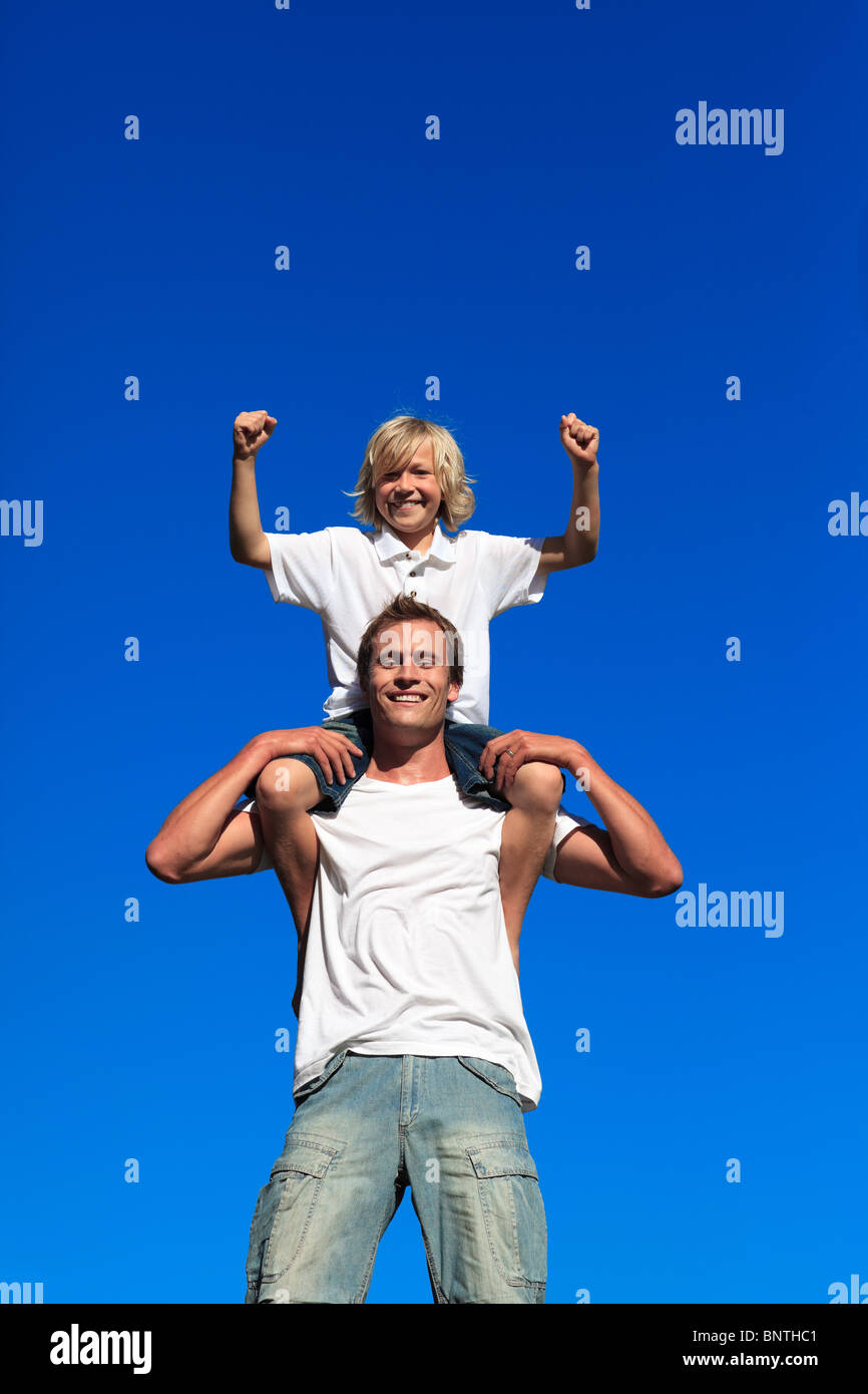 Father giving son piggy back hi-res stock photography and images - Alamy