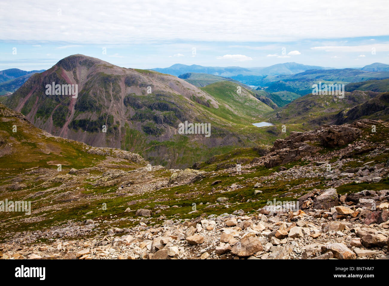 View from Scafell Pike, looking north-west with Great Gable in foreground, Styhead Tarn below and Derwent Water in far distance. Stock Photo