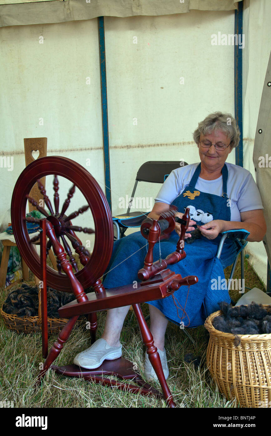 Woman At Spinning Wheel Making Yarn Stock Photo, Picture and