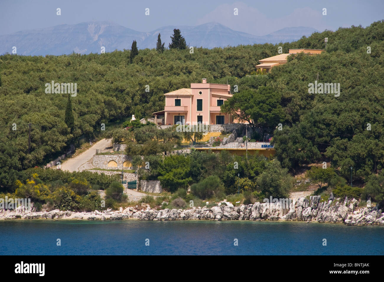 View of holiday villas in Kassiopi on the Greek Mediterranean island of Corfu Greece GR Stock Photo