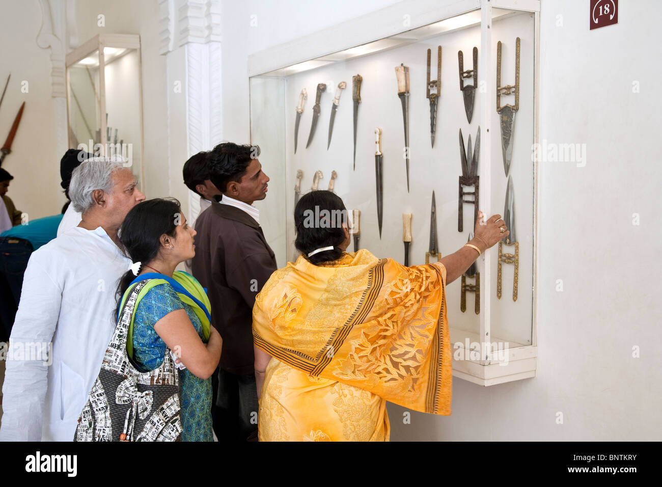 Indian tourists watching a daggers exhibition Meherangarh Fort Museum. Jodhpur. India Stock Photo