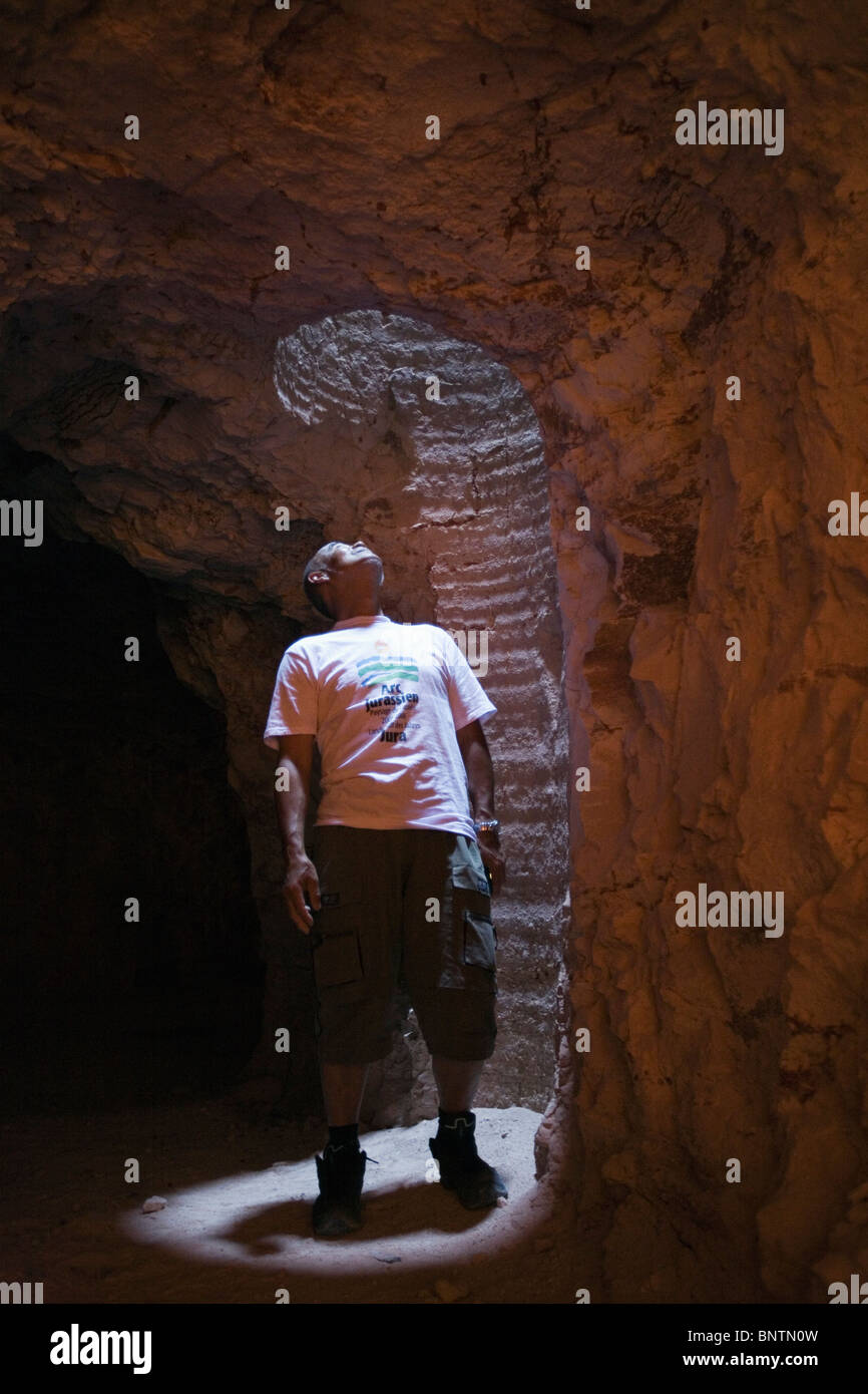 A tourist looks up through a mine shaft in an opal mine. Coober Pedy, South Australia, AUSTRALIA. Stock Photo