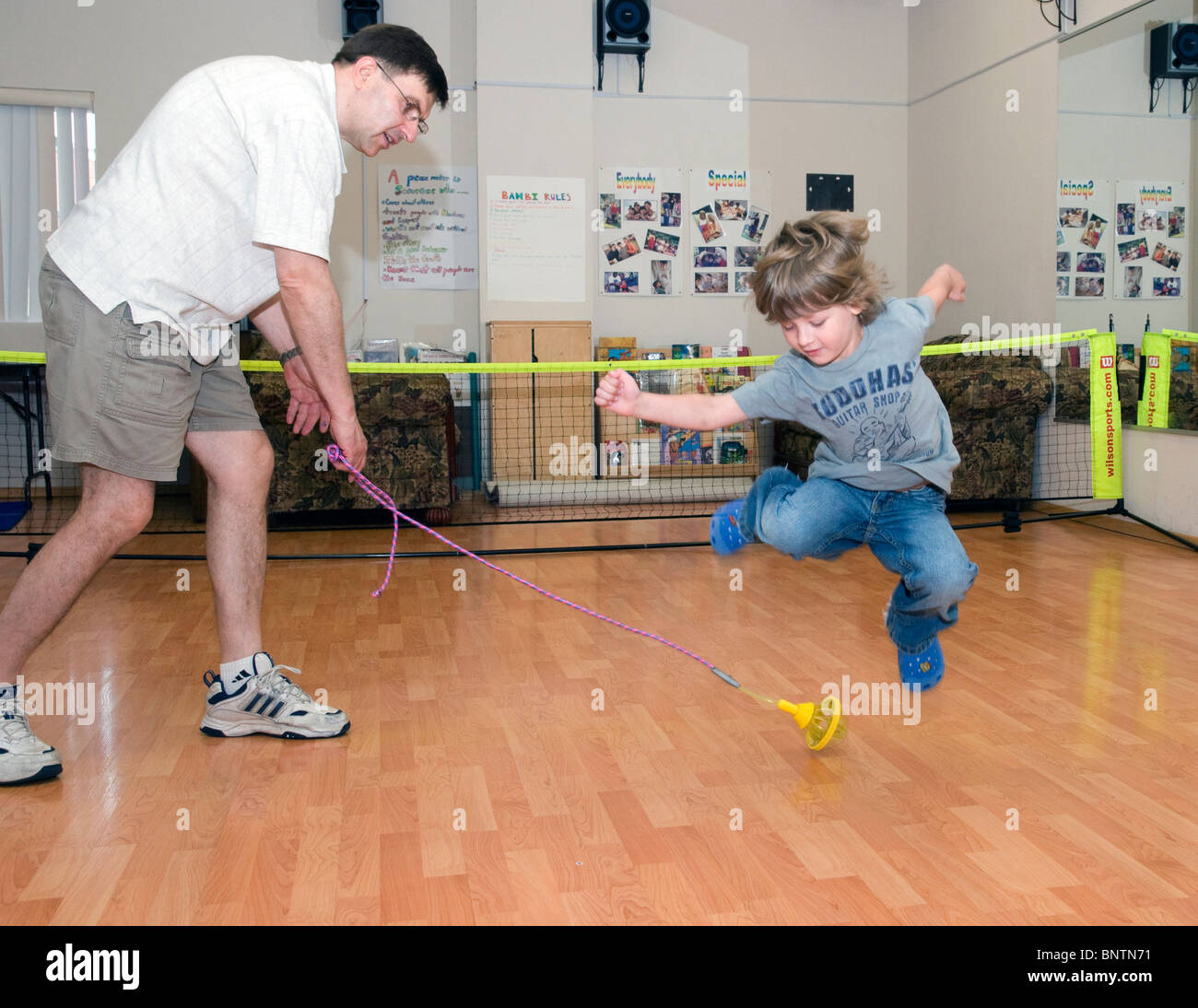 Kid jumping above skip rope.Tennis lesson for kids.Kindergarten Bamby, Philadelphia, PA, USA