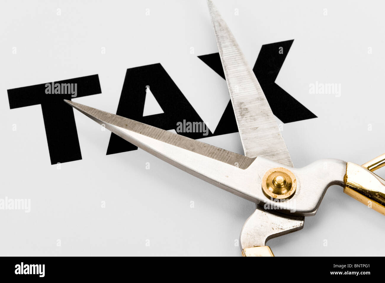 text of tax and scissors, concept of tax cut Stock Photo