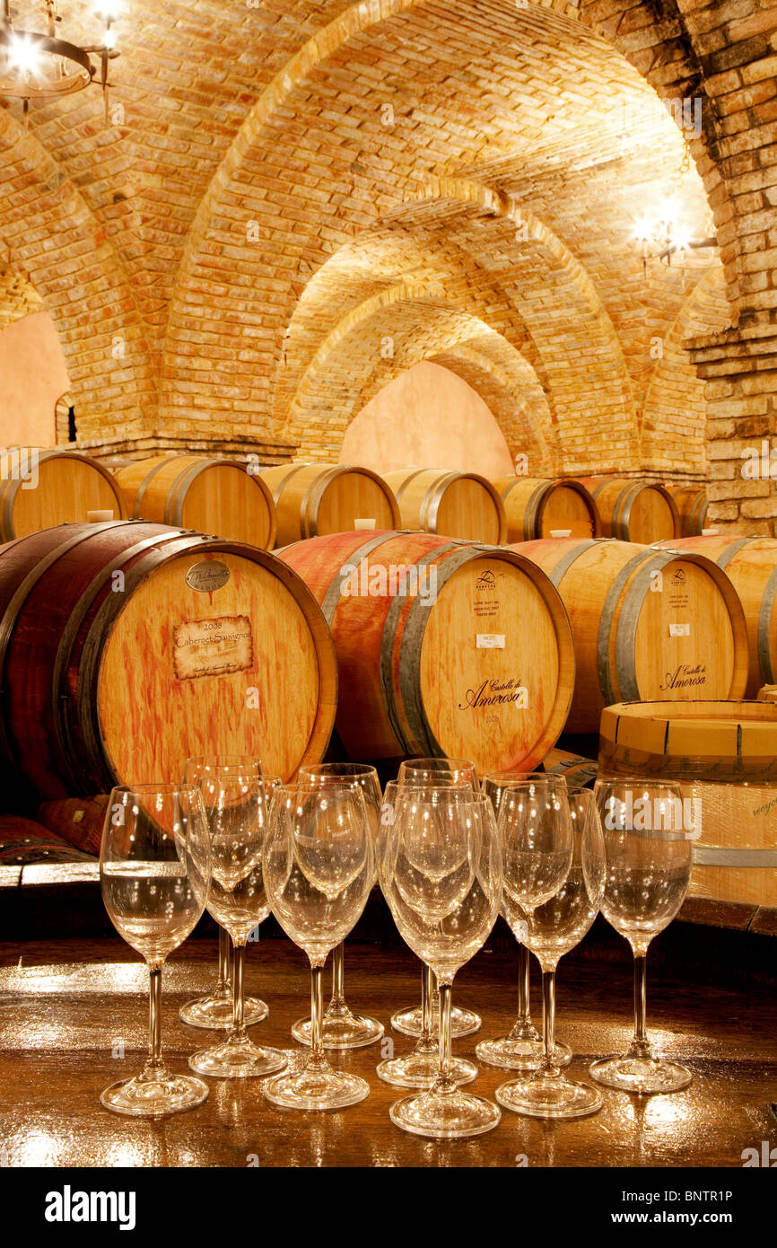 Wine aging in barrels in cellar with wine glasses. Castello di Amorosa. Napa Valley, California. Property released Stock Photo
