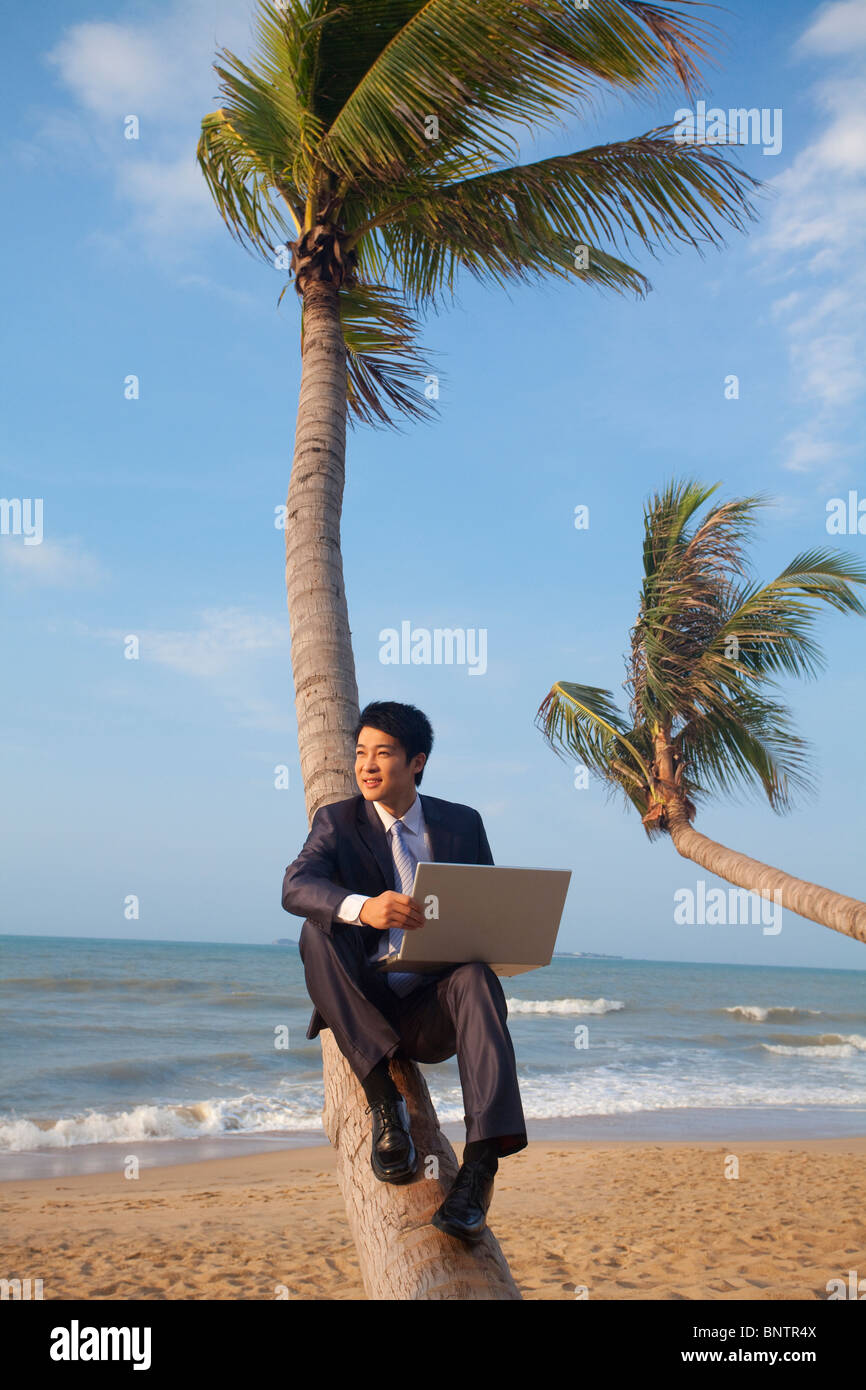 Businessman working at the beach Stock Photo