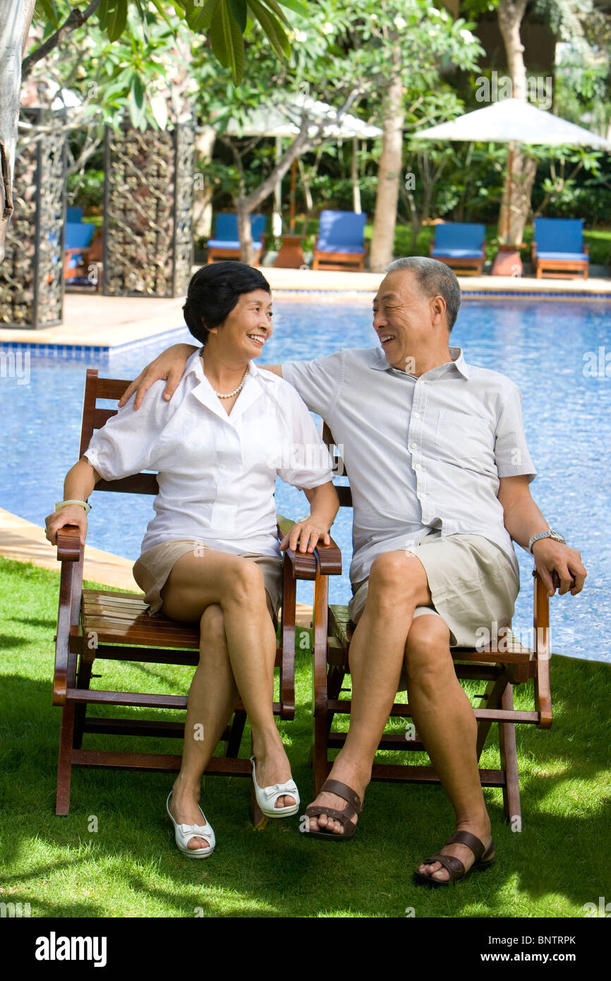 Portrait of a senior couple by the pool Stock Photo - Alamy
