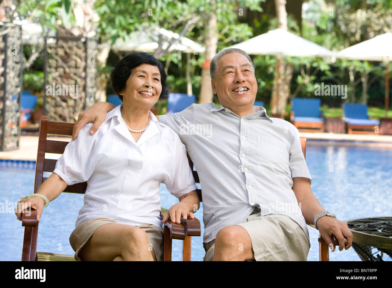 Portrait of a senior couple by the pool Stock Photo - Alamy
