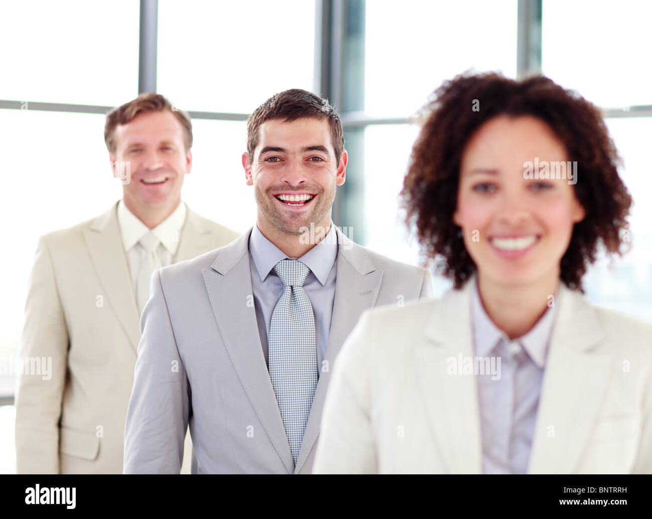 Young smiling businessman with his team Stock Photo - Alamy