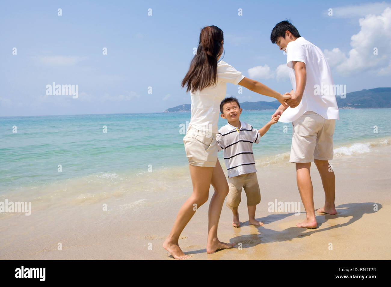 Young family on the beach Stock Photo - Alamy