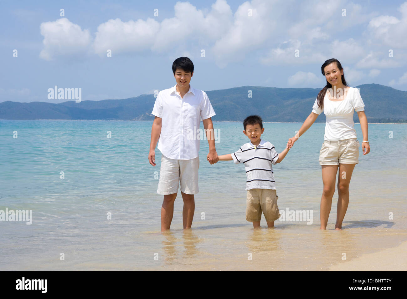 Young family on the beach Stock Photo - Alamy