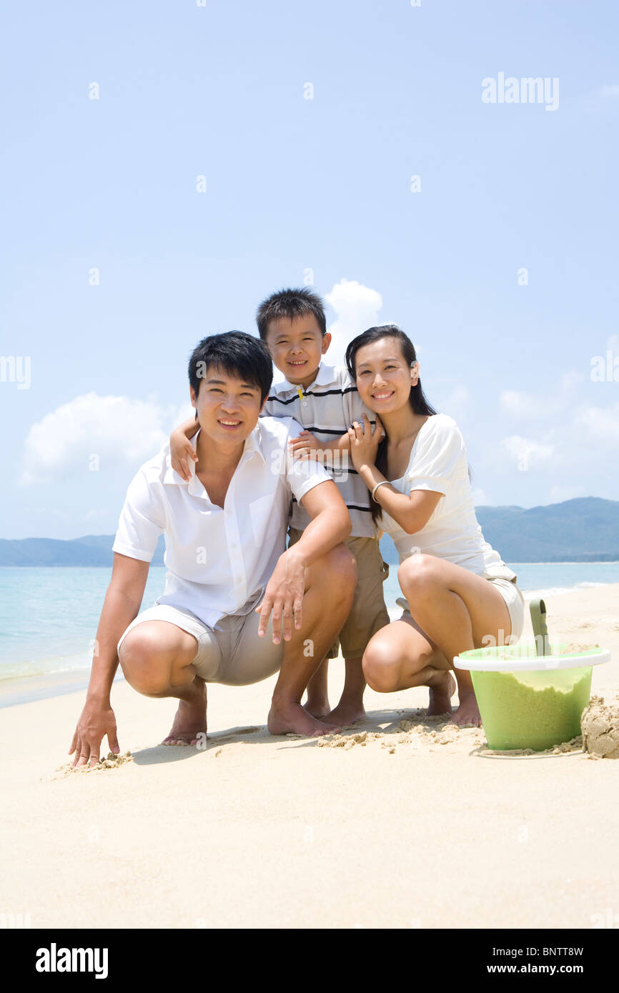 Young family playing on the beach Stock Photo - Alamy