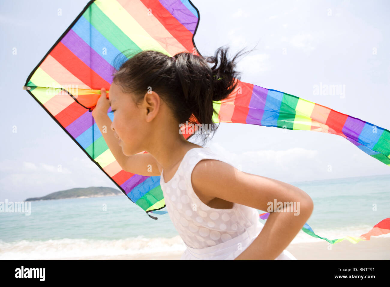 Girl flying a kite at the beach Stock Photo Alamy