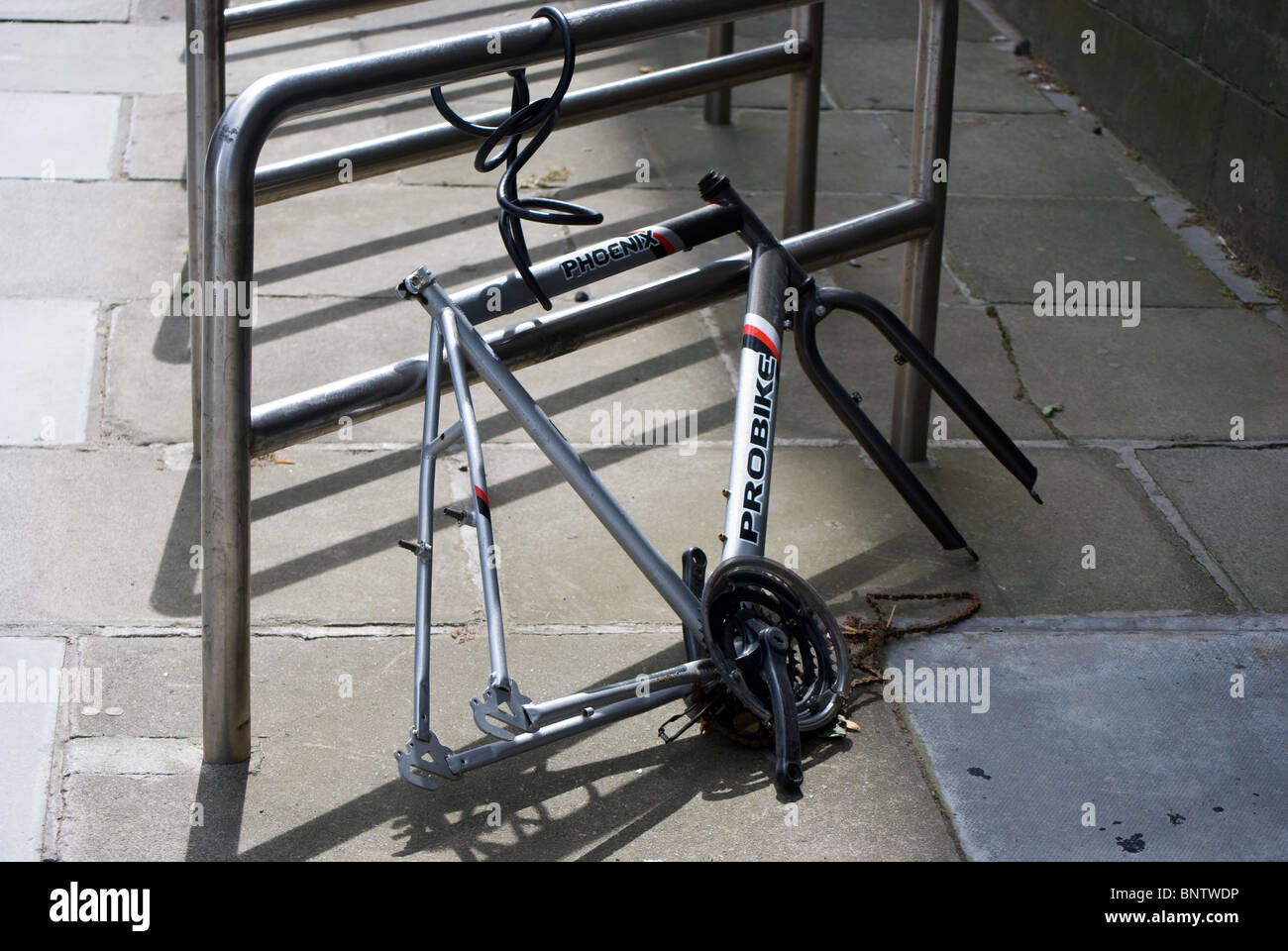 The remains of a bicycle chained to a bike rack in Edinburgh, Scotland Stock Photo Alamy