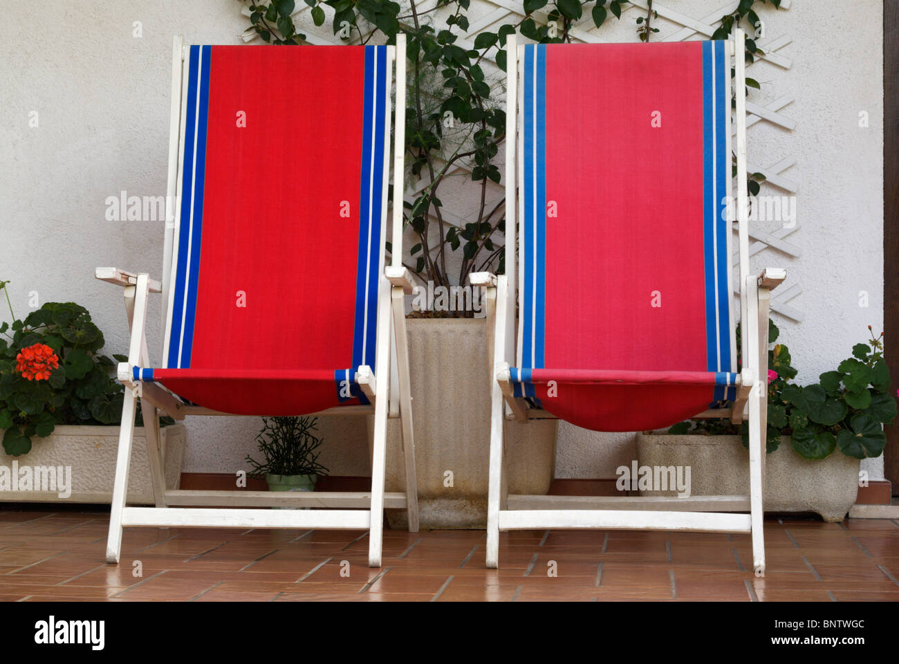 two deck chairs under porch Stock Photo Alamy