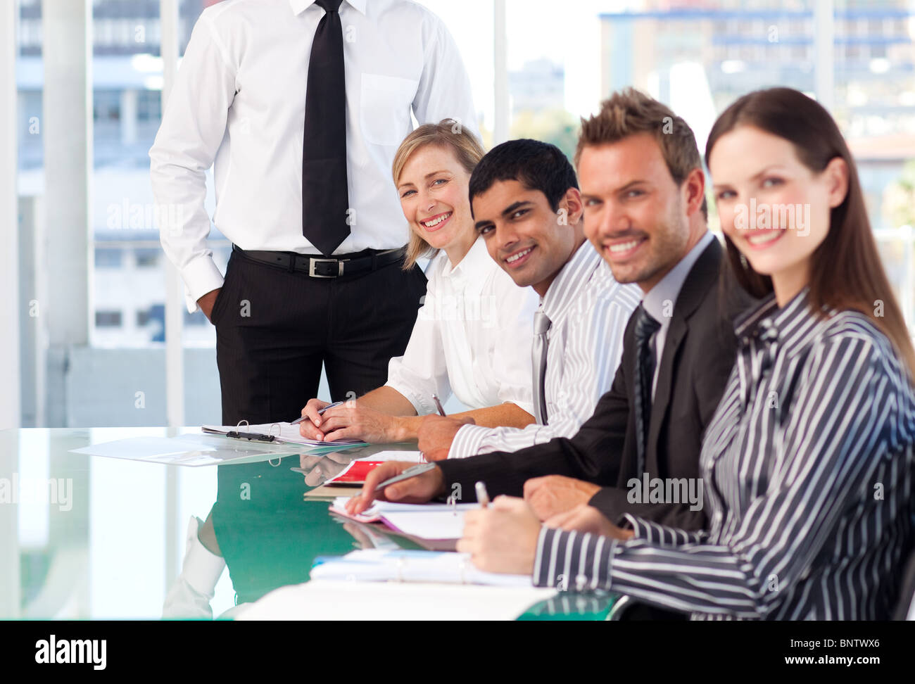 Business team working and smiling at the camera Stock Photo - Alamy