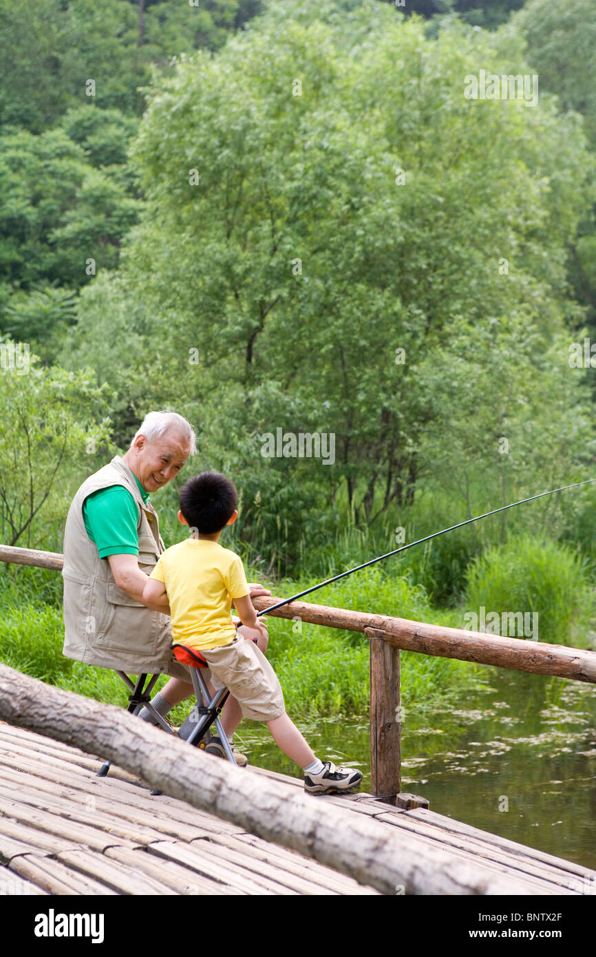 Two boys sitting fishing asia hi-res stock photography and images - Alamy