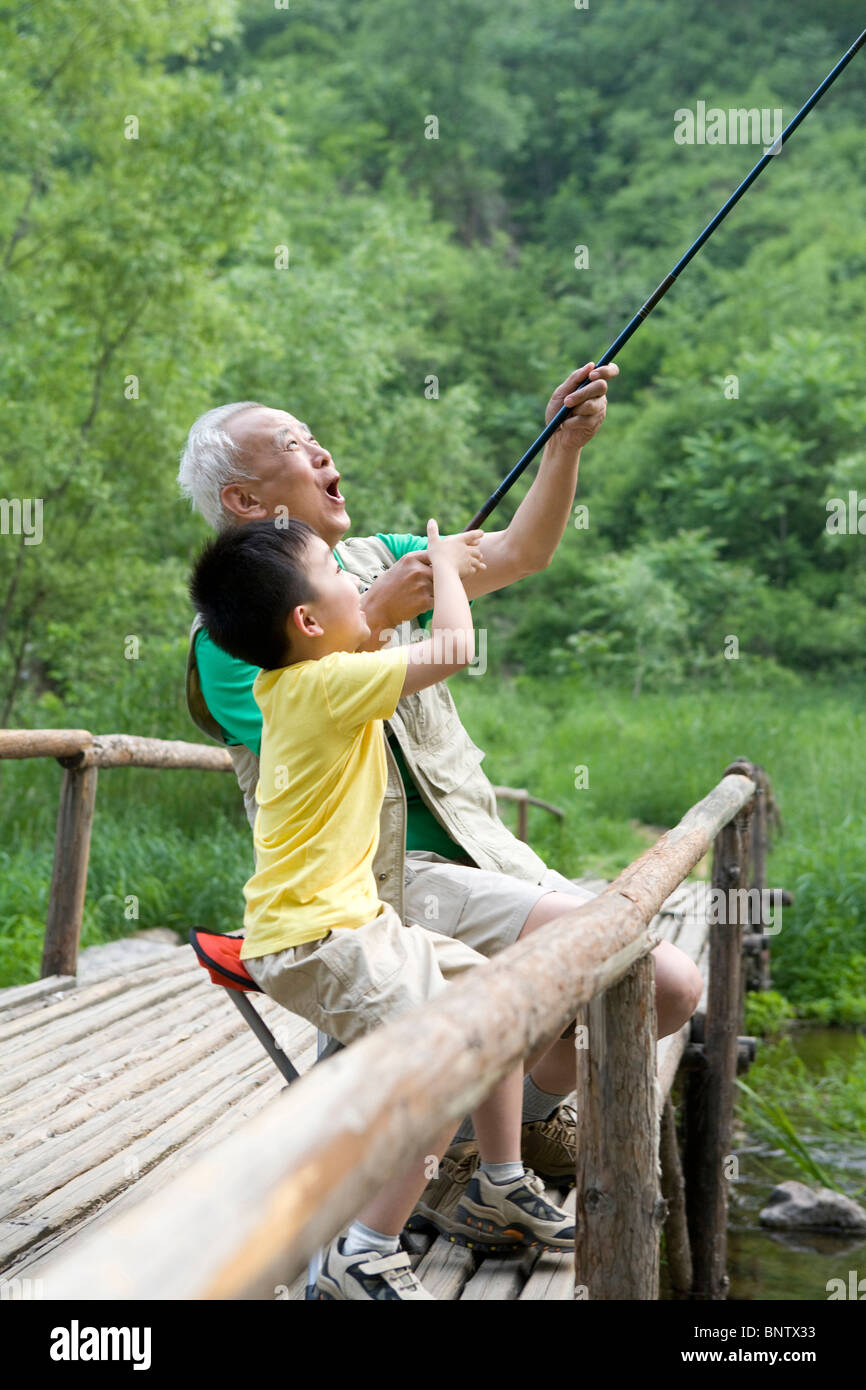 Two boys sitting fishing asia hi-res stock photography and images - Alamy