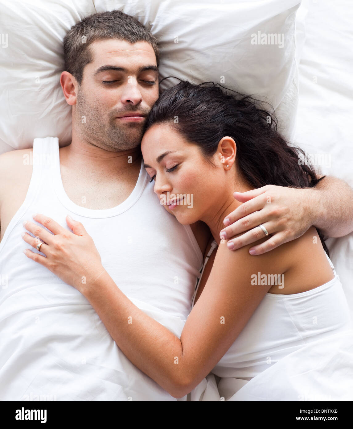 Radiant couple lying on a bed Stock Photo Alamy