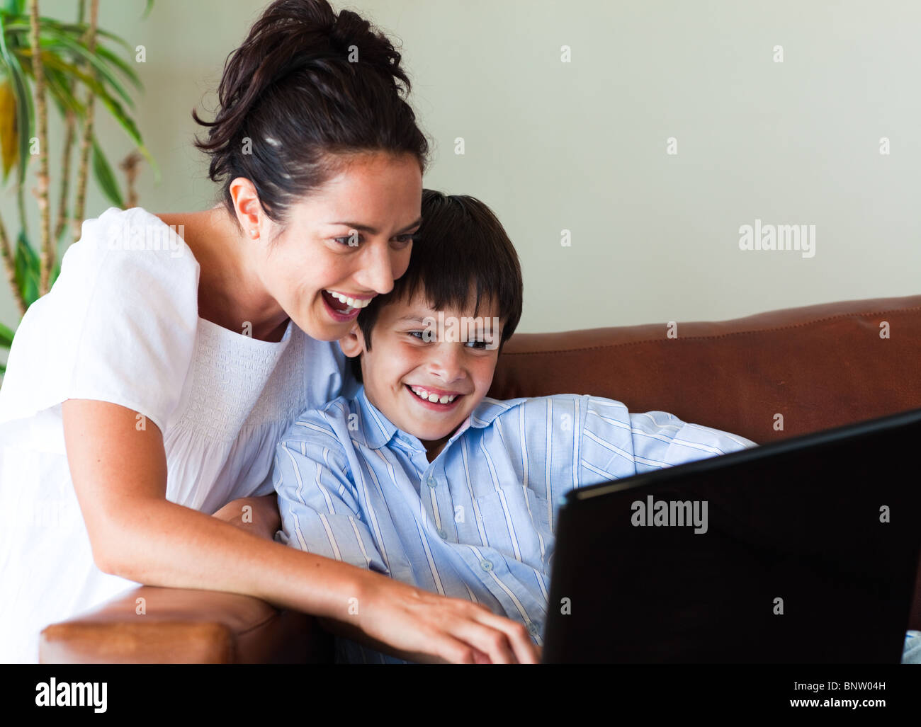 Сын увидел молодую маму. Сыну ноутбук. Мать с ребенком за компьютером.