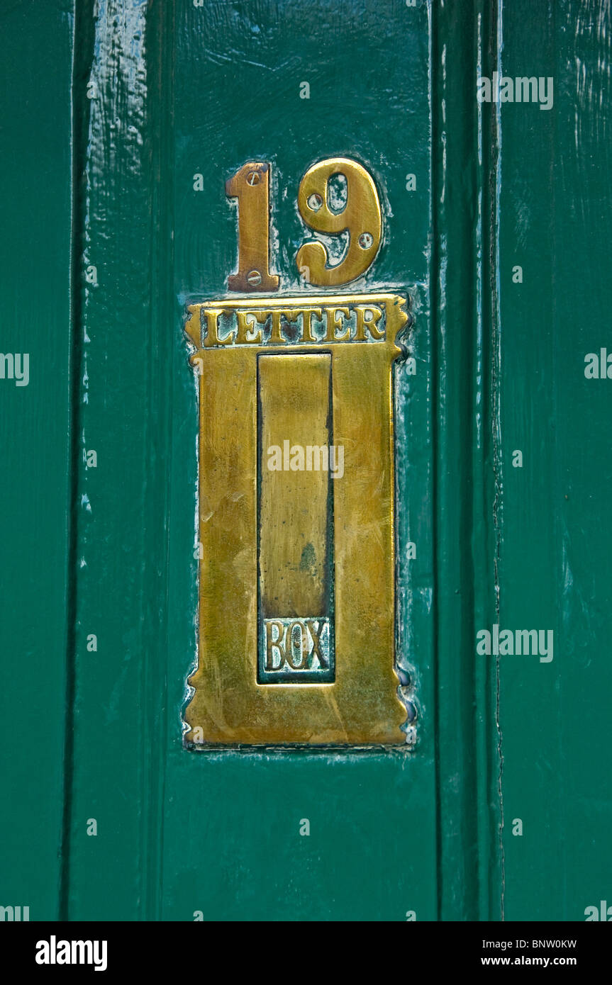 Close up of brass letter box letterbox on green door York North Yorkshire England UK United Kingdom GB Great Britain Stock Photo