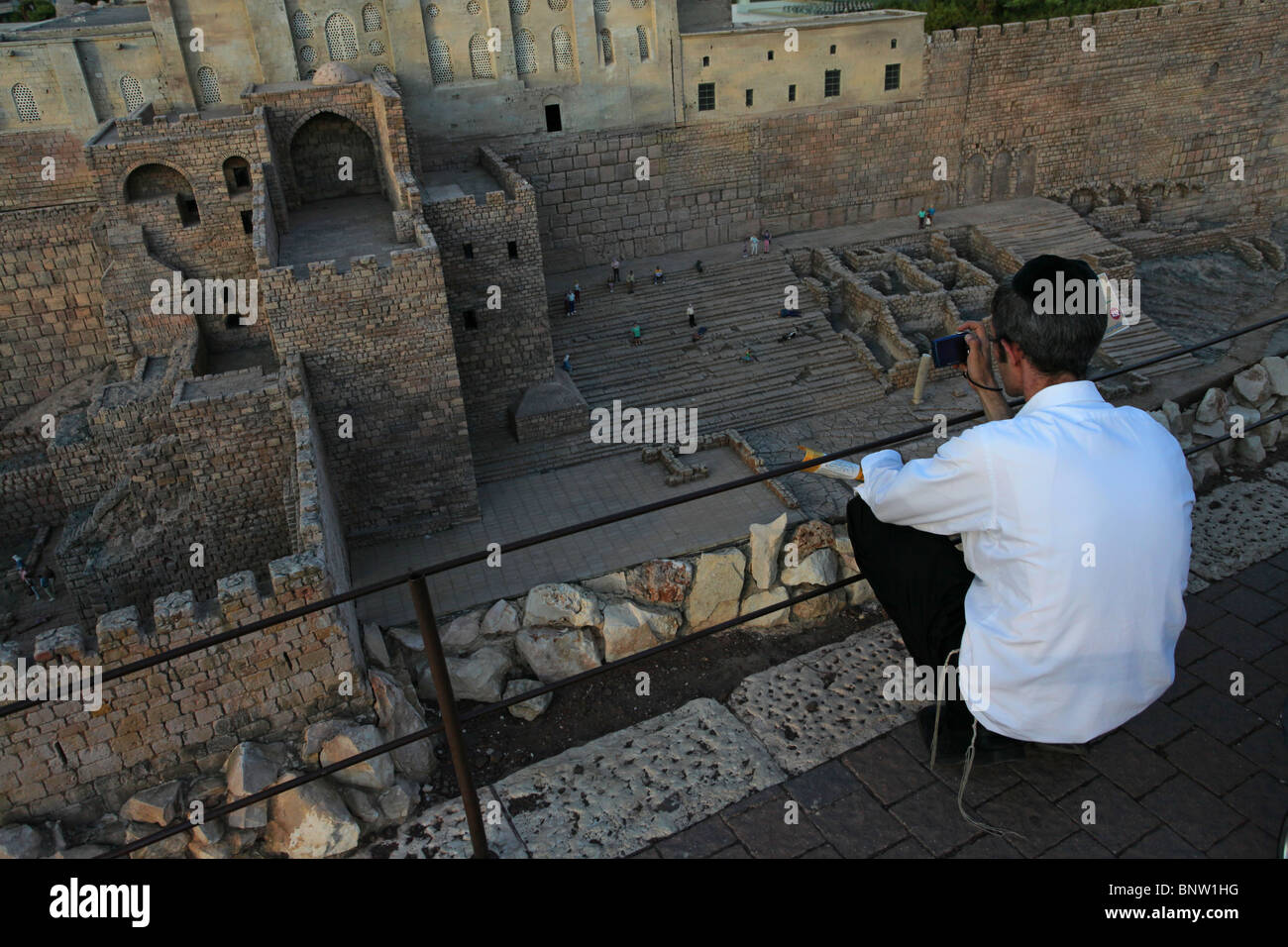 A religious Jew observing miniature replica of ancient city of David in Jerusalem displayed in Mini Israel a miniature park located near Latrun, in the Ayalon Valley. Israel the site contains miniature replicas of hundreds of buildings and landmarks in Israel. Stock Photo