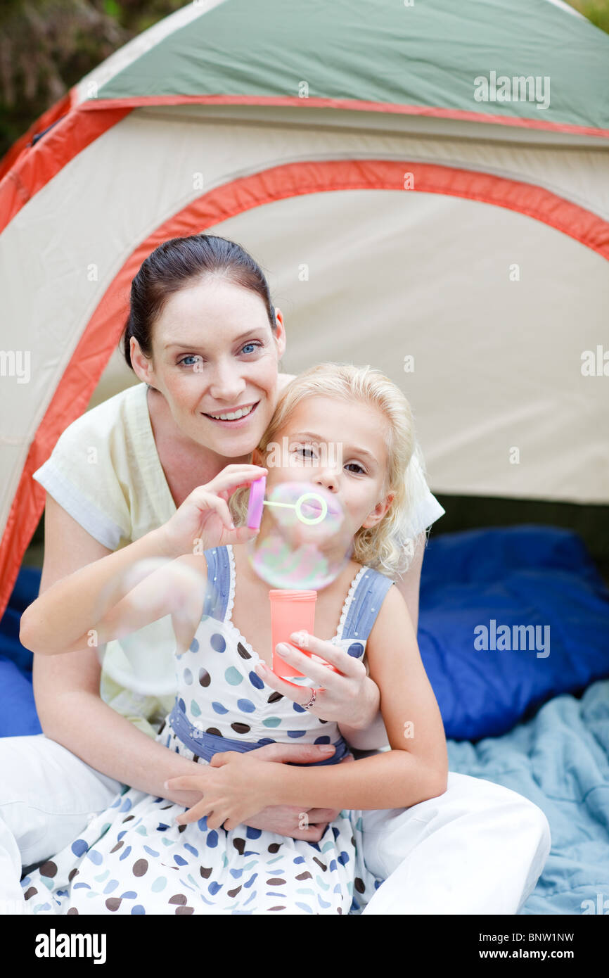 Mother and daughter blowing bubbles Stock Photo Alamy