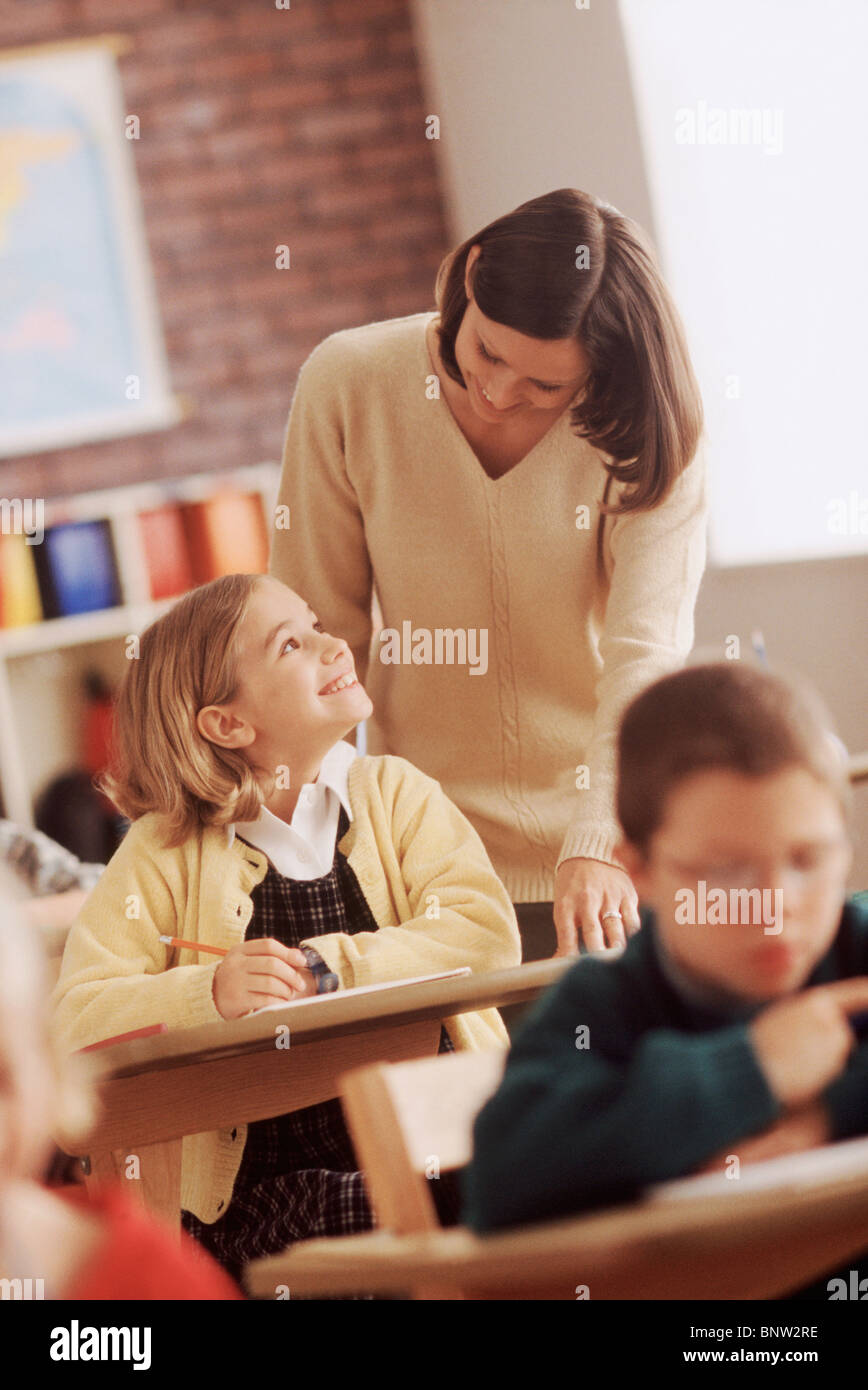 Elementary school student talking to teacher Stock Photo - Alamy