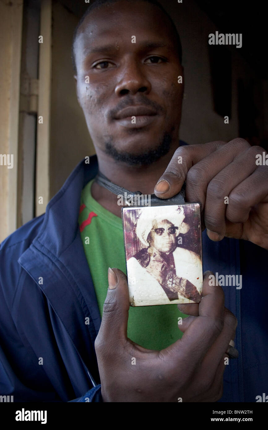 Man holding up his Baye Fall mouride muslim necklace, The Gambia Stock Photo