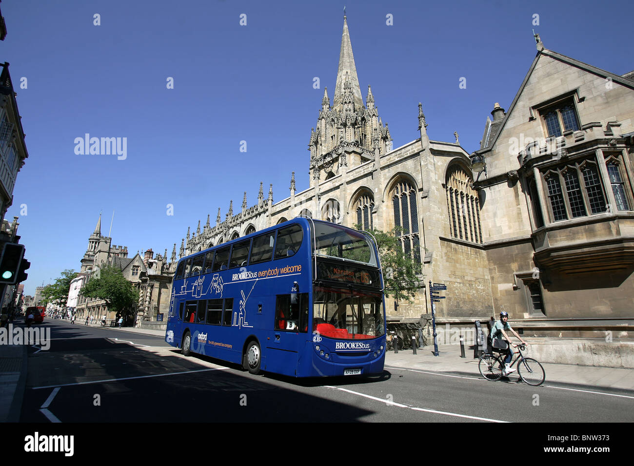 A bus passes the All Souls College on Oxford High Street. Stock Photo