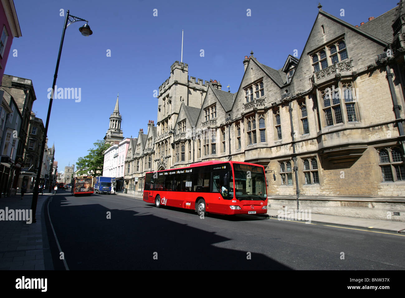 A bus passes the All Souls College on Oxford City High Street. Stock Photo