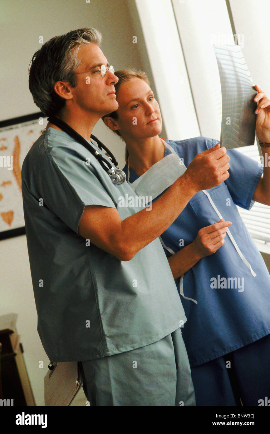 Doctor and nurse looking at chart Stock Photo