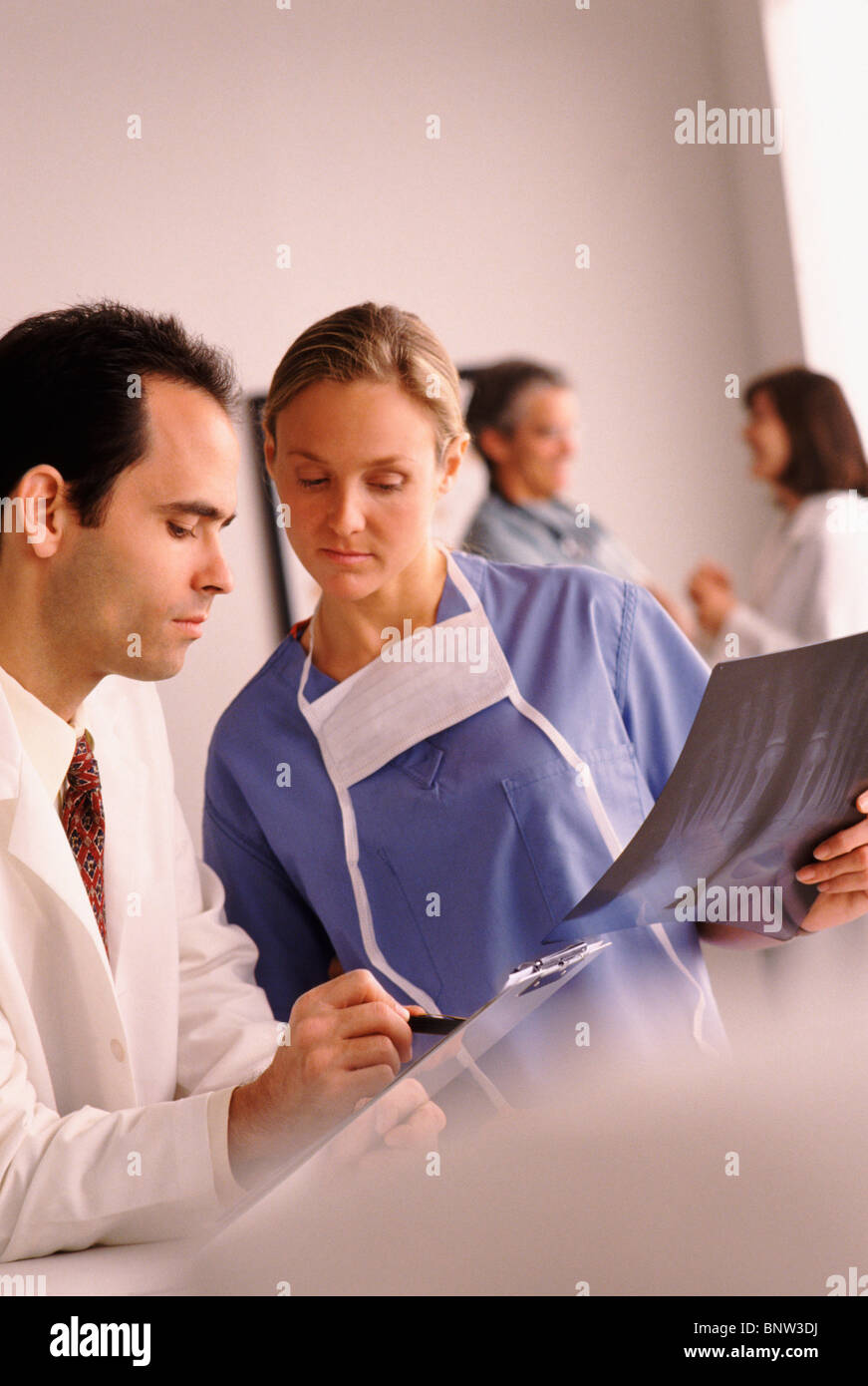 Doctor and nurse looking at chart Stock Photo