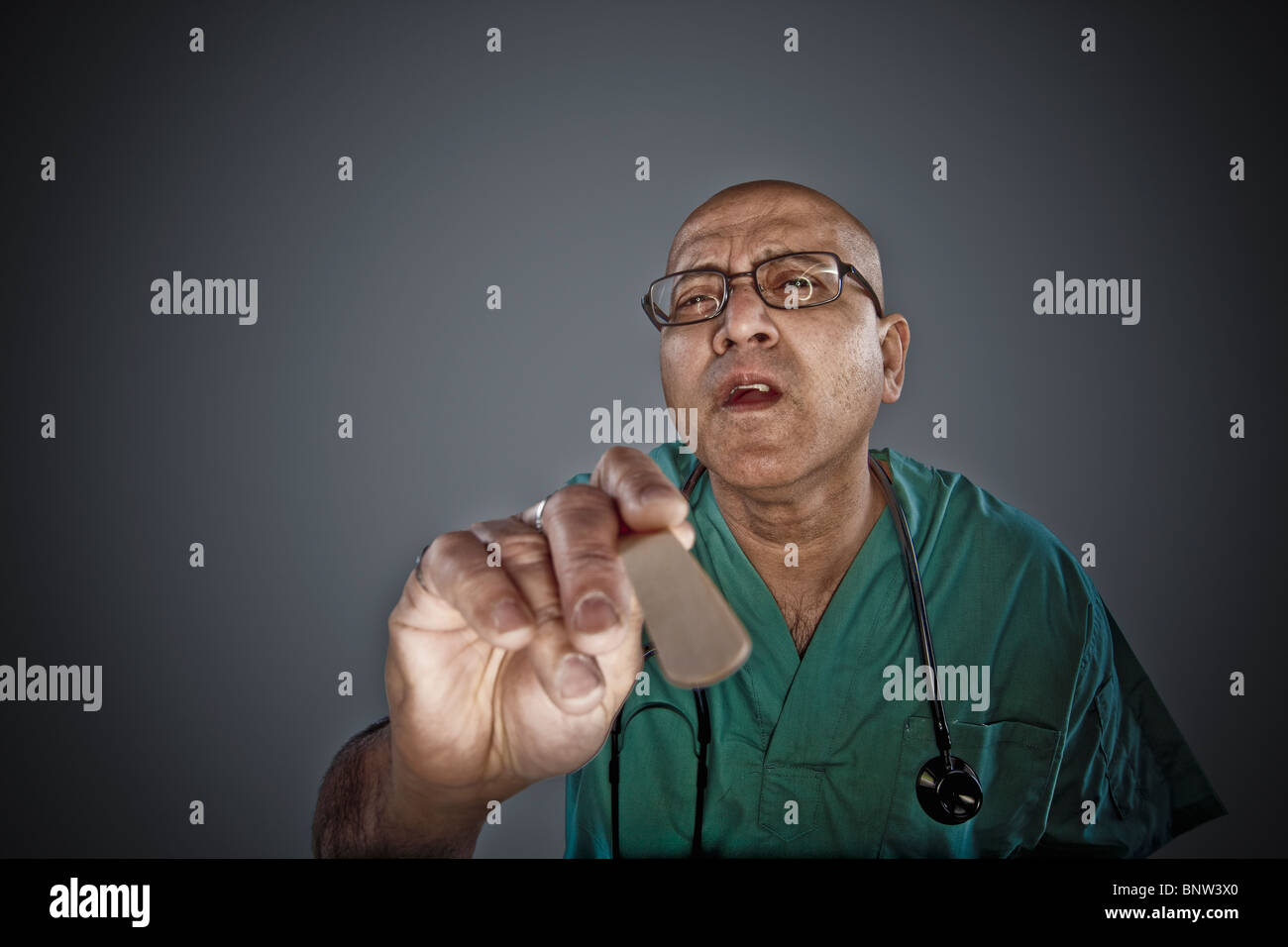 Doctor holding a tongue depressor Stock Photo Alamy