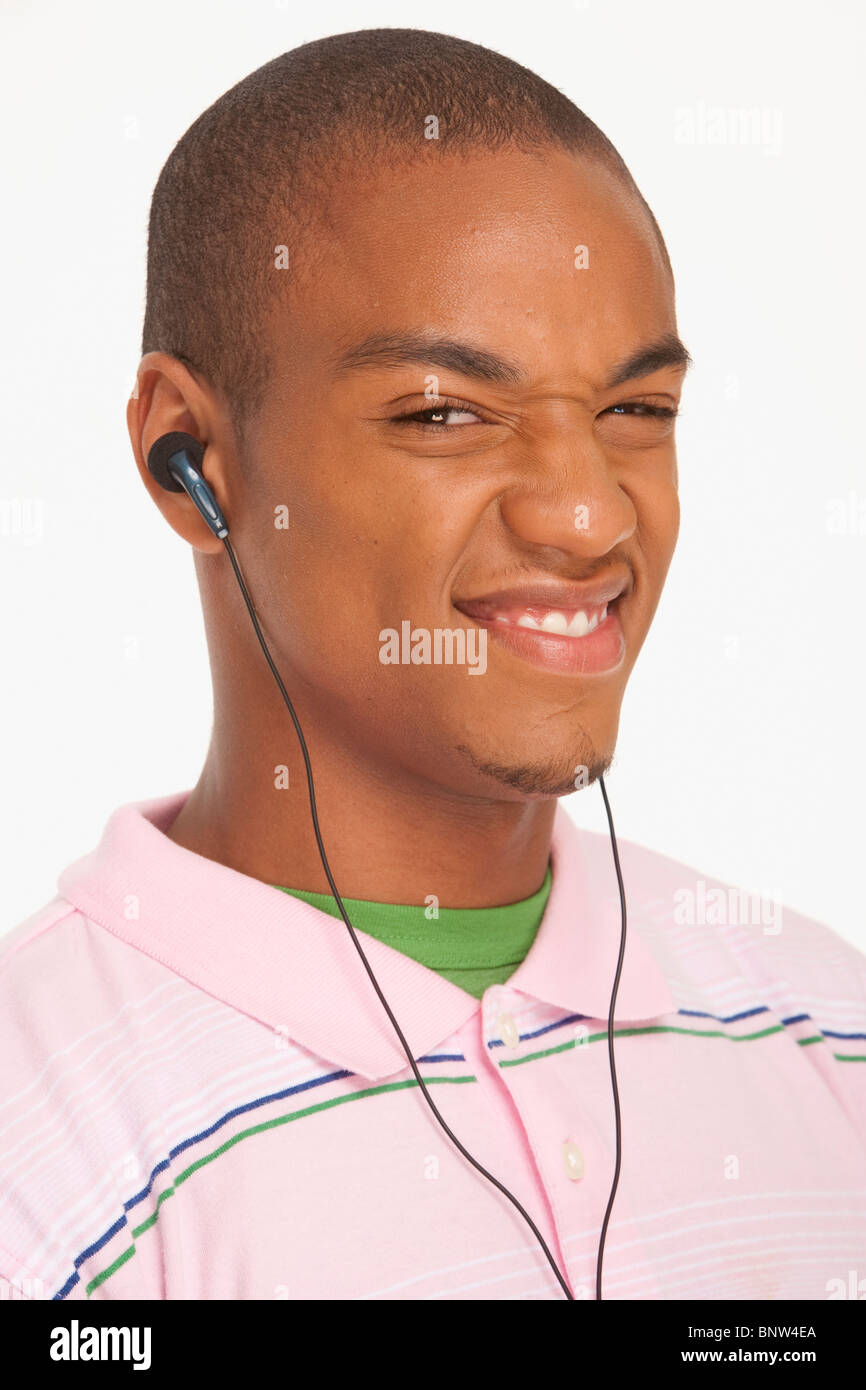 Man wearing earphones making a funny face Stock Photo Alamy
