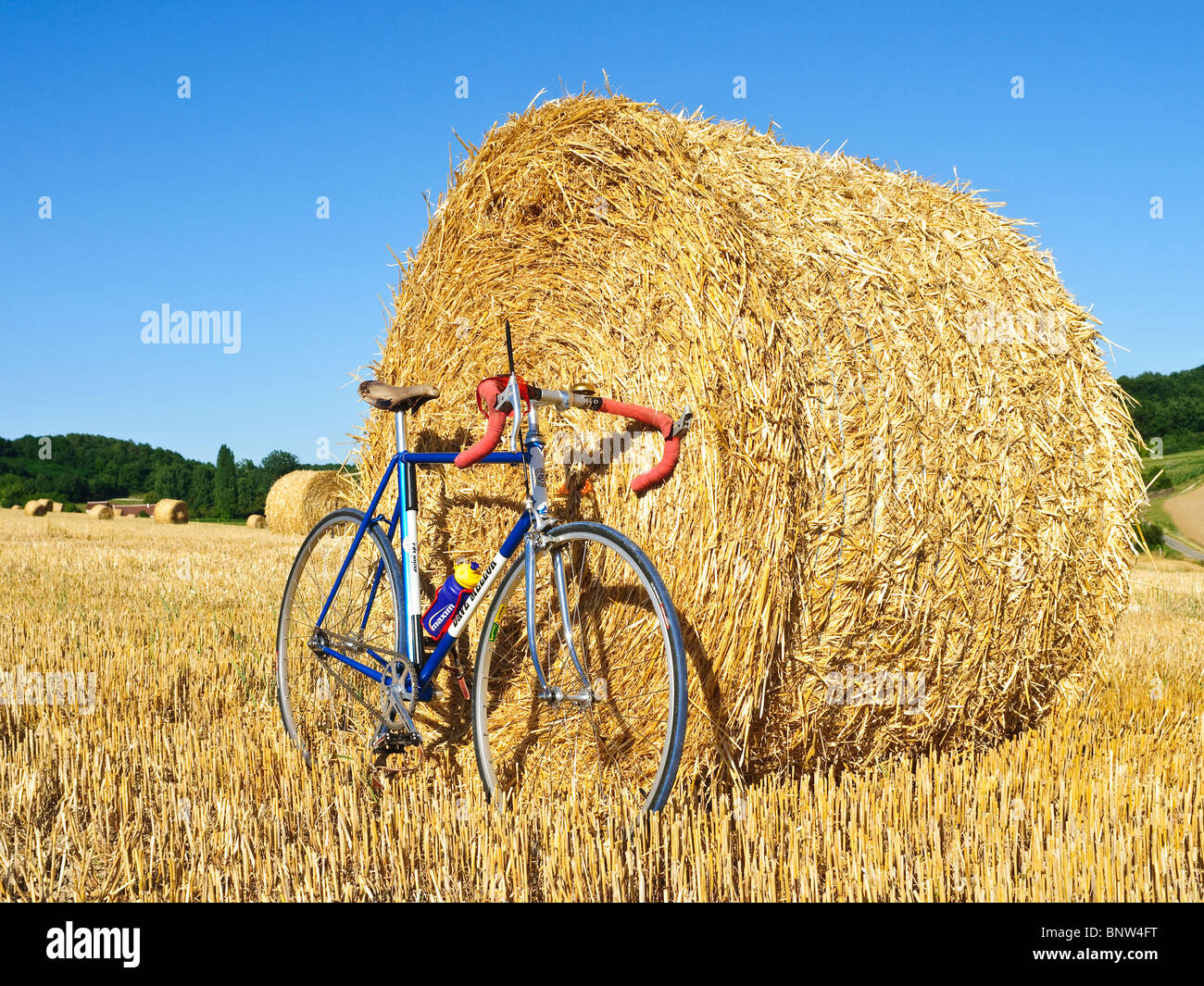 Fixed wheel bicycle in front of round straw bale - Indre-et-Loire, France. Stock Photo