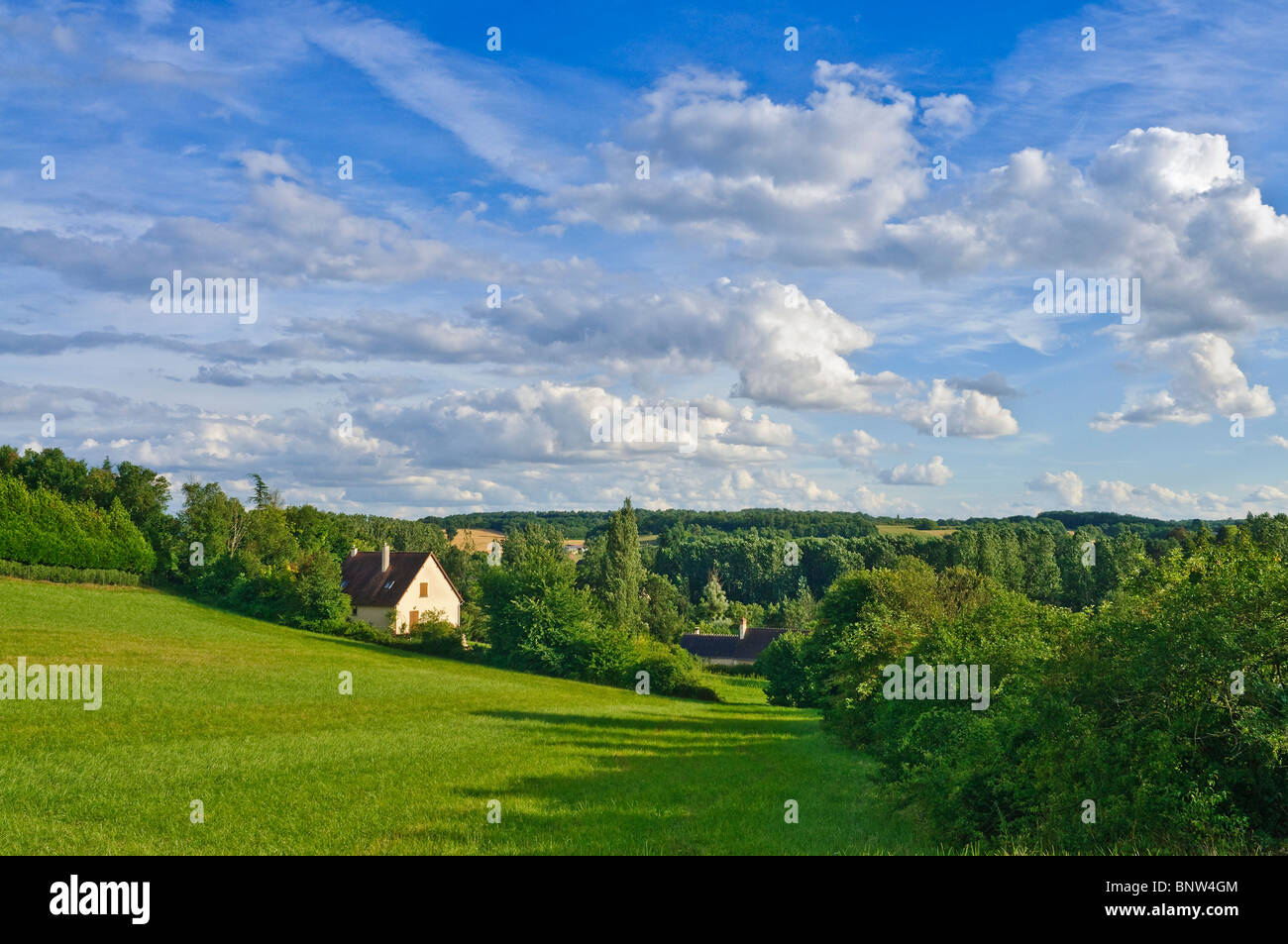 House in gently rolling, wooded landscape - sud-Touraine, France. Stock Photo